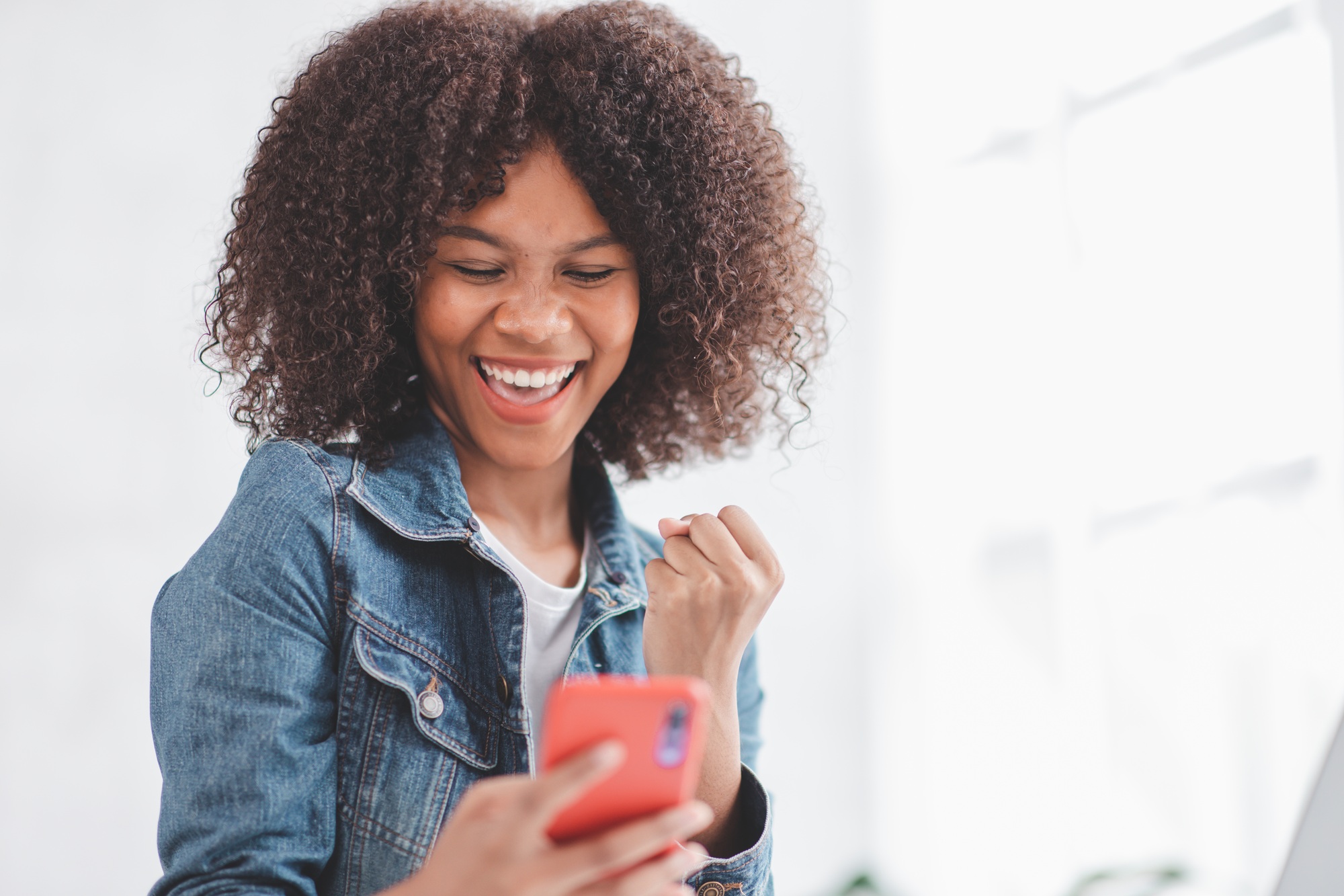 Excited happy woman african american looking at tablet screen, celebrating an online win, overjoyed